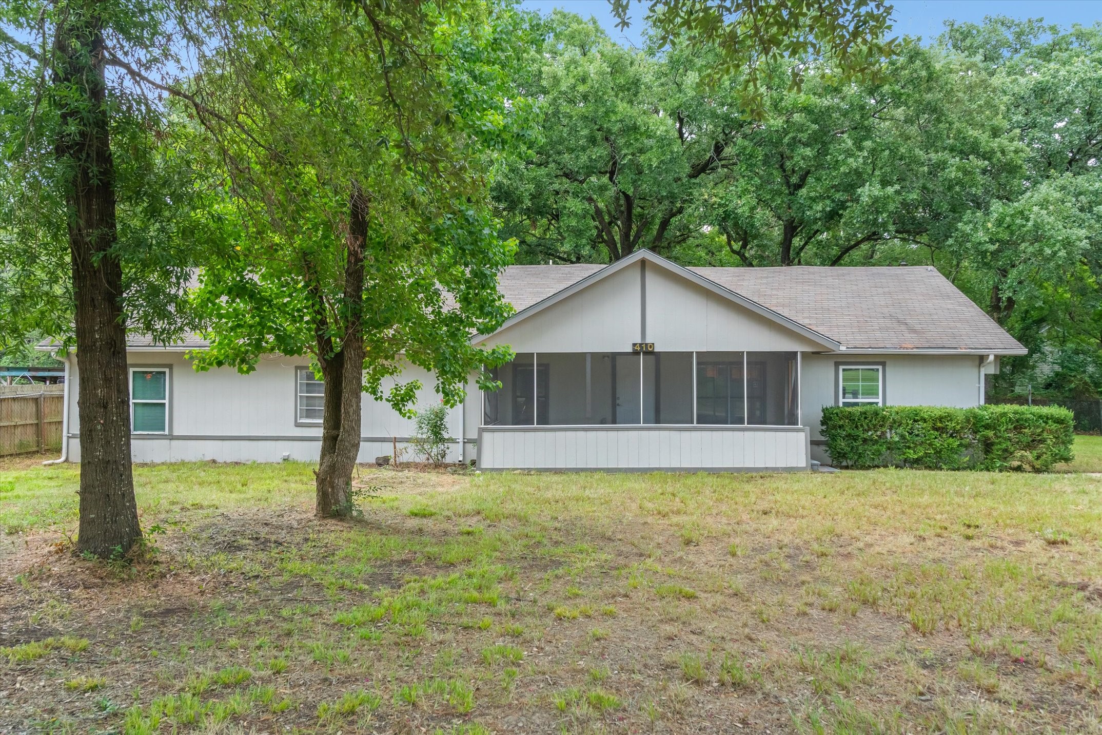 a house that has a tree in front of it