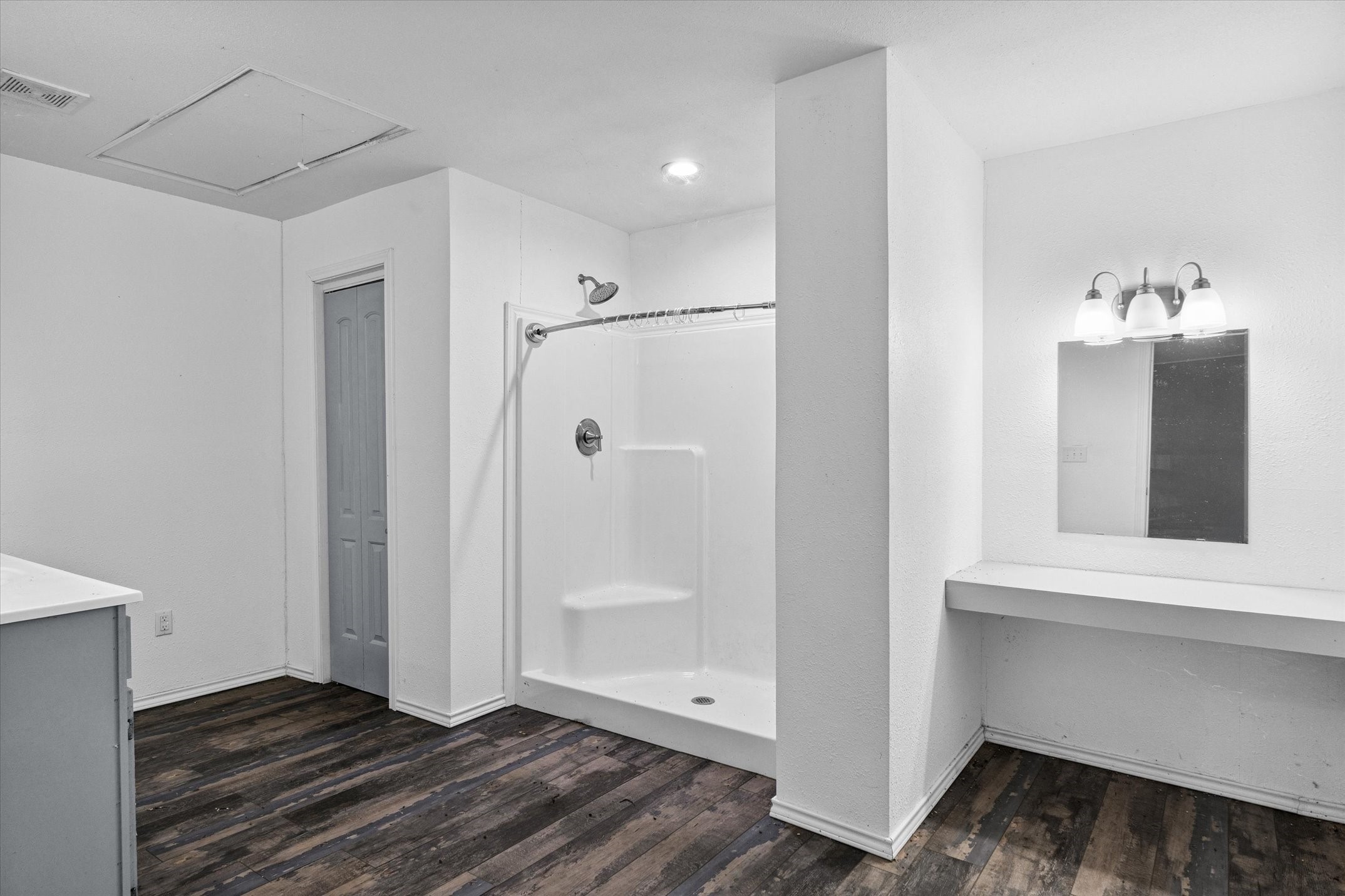 410 Pleasure Land Road Gun Barrel City, TX 75156 - Photo 24 of 33 a view of an empty room with wooden floor and a bathroom