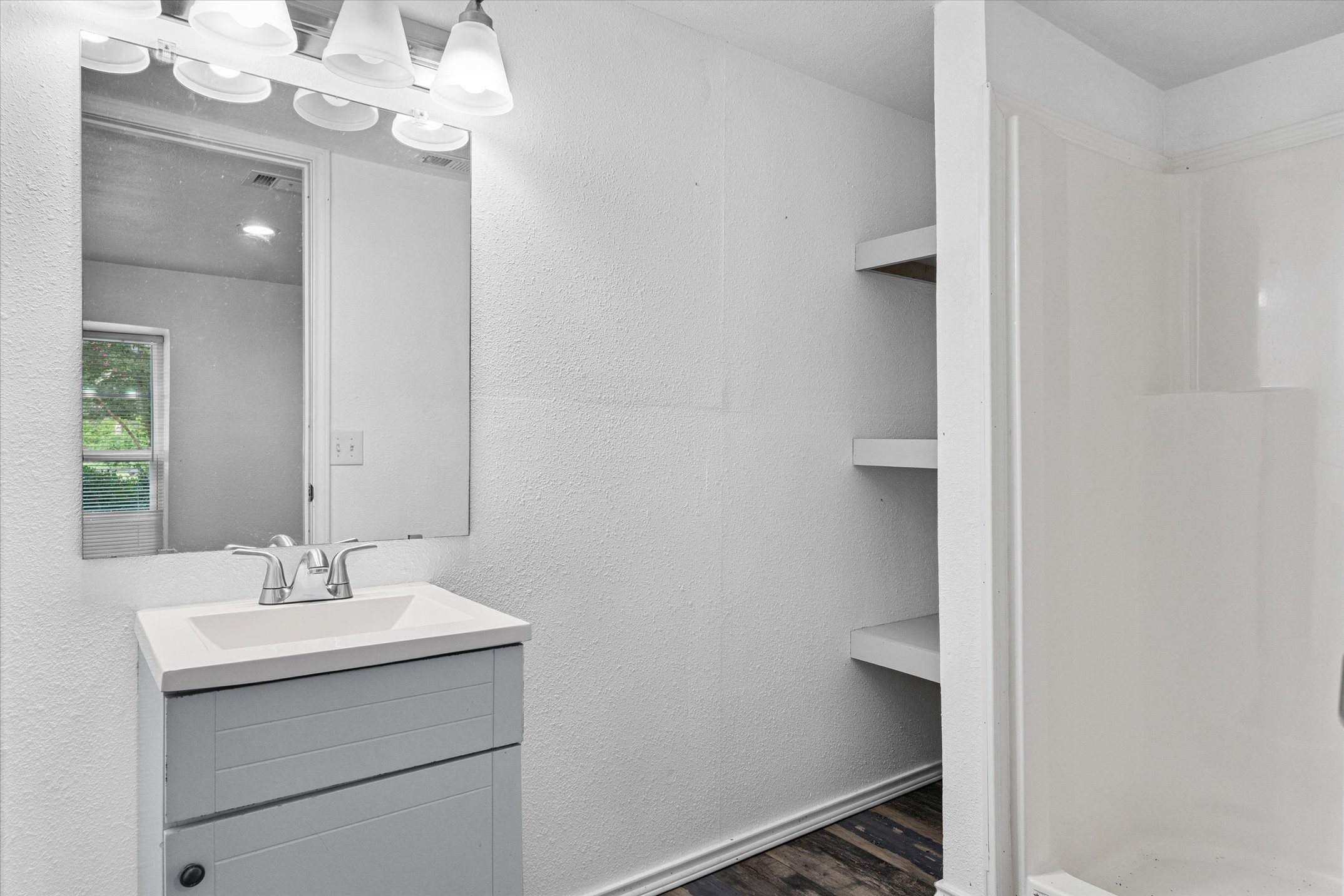 410 Pleasure Land Road Gun Barrel City, TX 75156 - Photo 30 of 33 a bathroom with a sink vanity and a mirror
