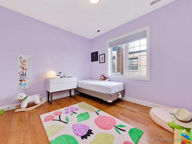 1453 West Irving Park Road, Unit 304 Chicago, IL 60613 - Photo 13 of 17 a bedroom with a bed and a dresser