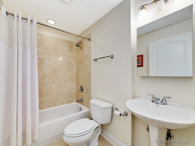1453 West Irving Park Road, Unit 304 Chicago, IL 60613 - Photo 14 of 17 a bathroom with a sink a toilet and shower