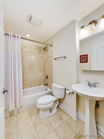 1453 West Irving Park Road, Unit 304 Chicago, IL 60613 - Photo 15 of 17 a bathroom with a sink toilet and shower