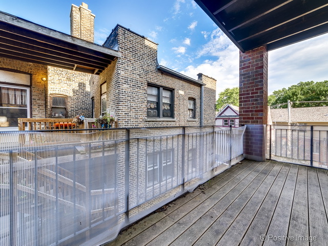 1453 West Irving Park Road, Unit 304 Chicago, IL 60613 - Photo 17 of 17 a view of a porch with wooden floor