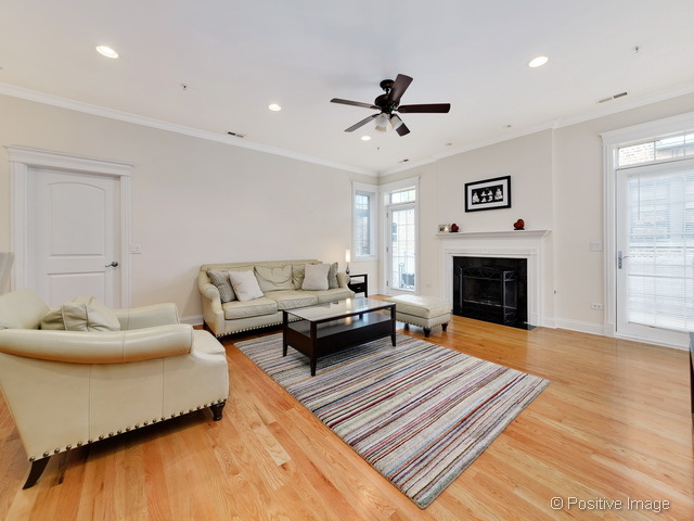 1453 West Irving Park Road, Unit 304 Chicago, IL 60613 - Photo 2 of 17 a living room with furniture and a fireplace