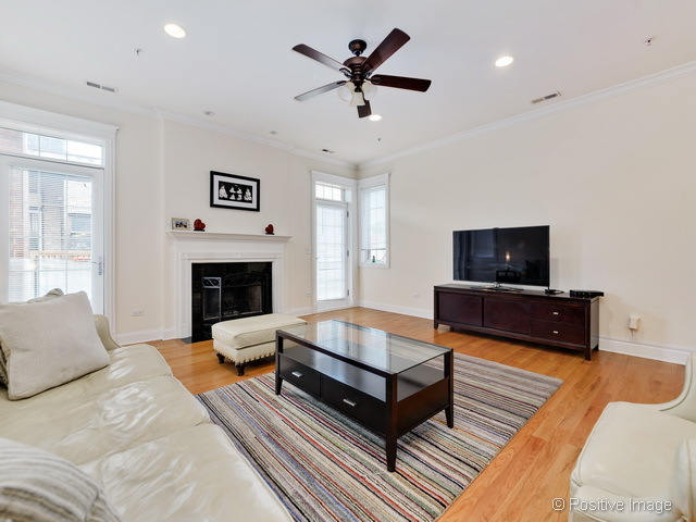 1453 West Irving Park Road, Unit 304 Chicago, IL 60613 - Photo 3 of 17 a living room with furniture and a fireplace