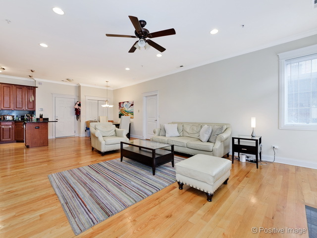 1453 West Irving Park Road, Unit 304 Chicago, IL 60613 - Photo 4 of 17 a living room with furniture and a wooden floor