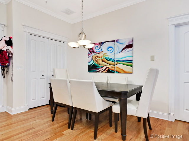 1453 West Irving Park Road, Unit 304 Chicago, IL 60613 - Photo 9 of 17 a view of a room with furniture and wooden floor