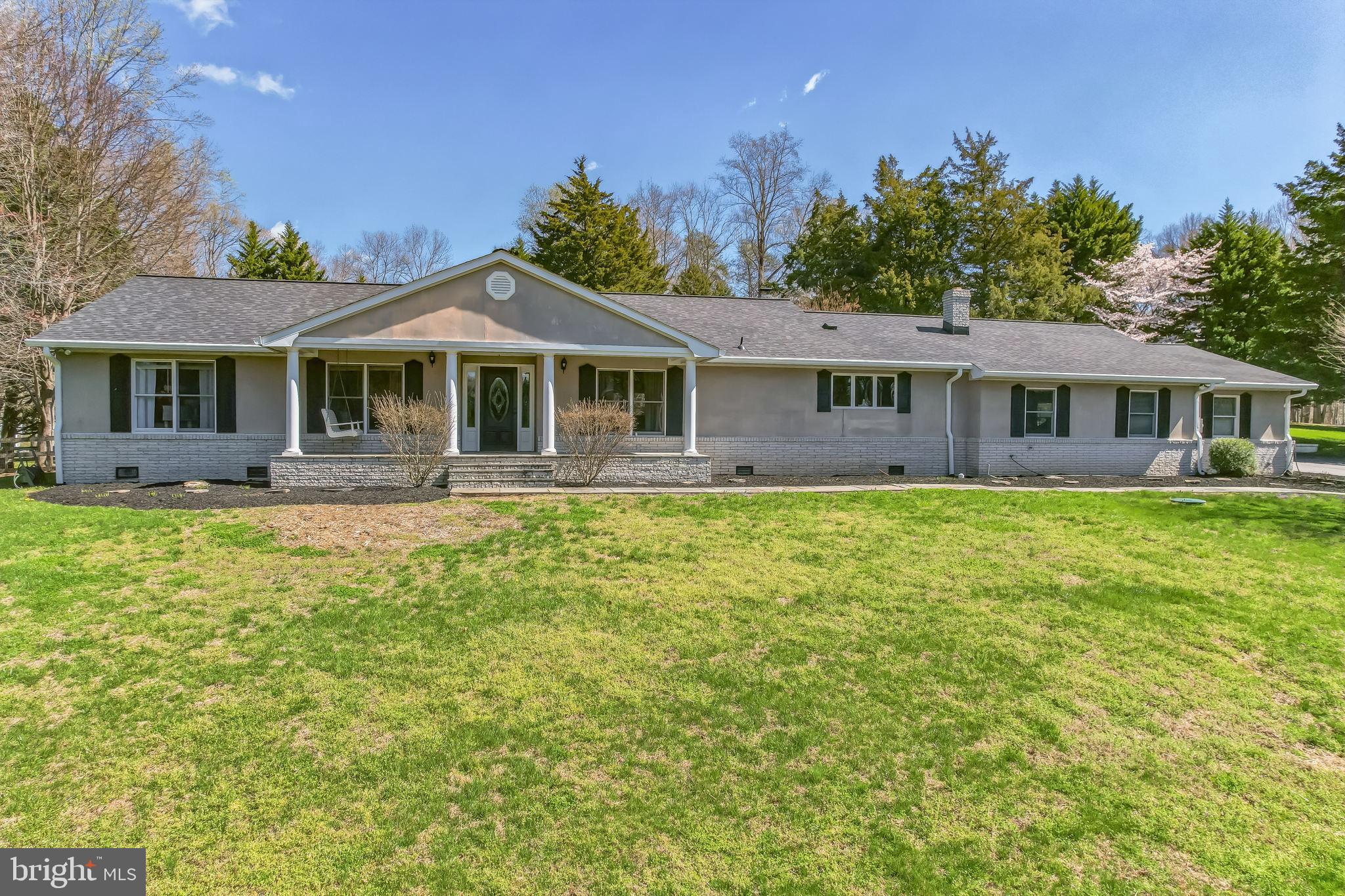 3310 Holland Cliffs Road Huntingtown, MD 20639 - Photo 2 of 40 a front view of a house with a yard table and chairs