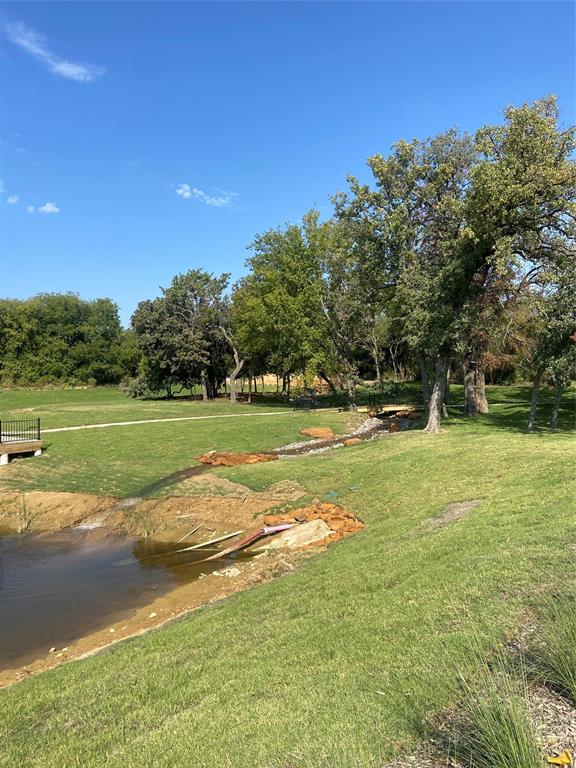 109 Park Avenue Keller, TX 76248 - Photo 2 of 3 a view of a golf course with a lake