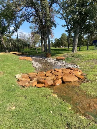 a view of a park with large trees