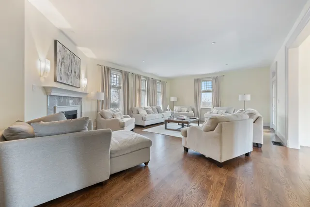a living room with fireplace furniture and a wooden floor