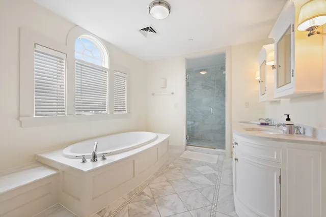 a bathroom with a sink a toilet a mirror and shower