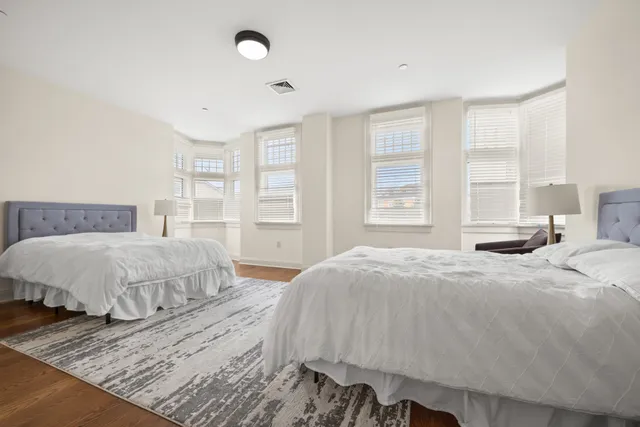 a bedroom with a large bed and a window