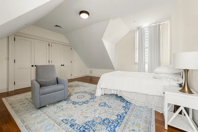 a bedroom with a large bed and a couch