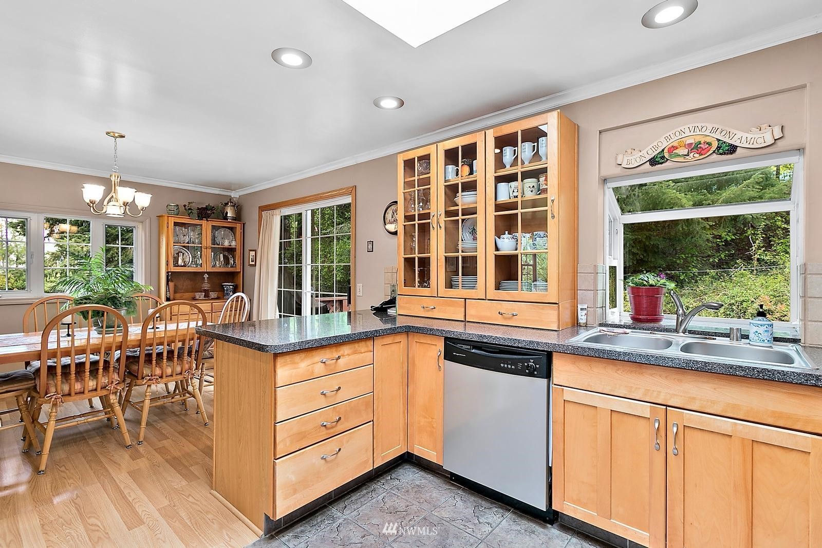 509 Roe Street Steilacoom, WA 98388 - Photo 11 of 40 a kitchen with granite countertop a stove and a sink