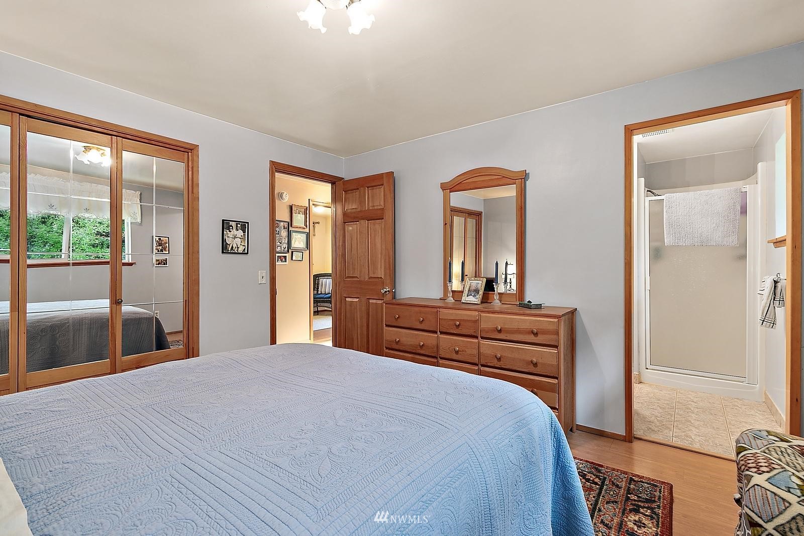 509 Roe Street Steilacoom, WA 98388 - Photo 15 of 40 a bedroom with a bed and a large mirror on the dresser
