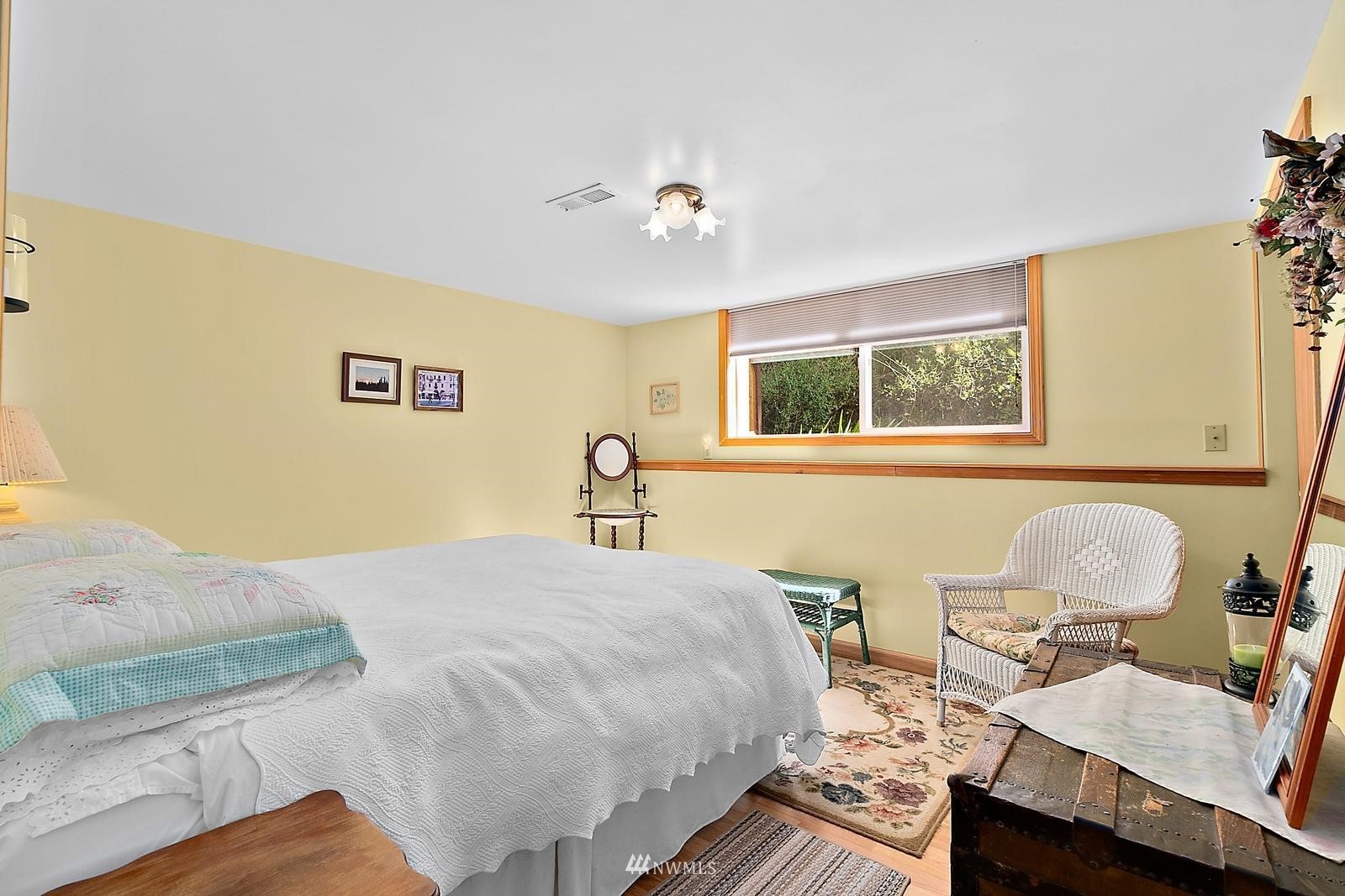 509 Roe Street Steilacoom, WA 98388 - Photo 17 of 40 a bedroom with a bed and wooden floor