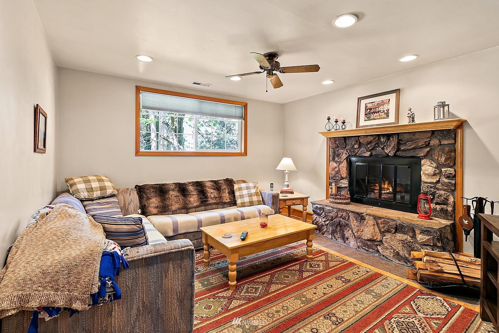 509 Roe Street Steilacoom, WA 98388 - Photo 24 of 40 a living room with furniture and a fireplace