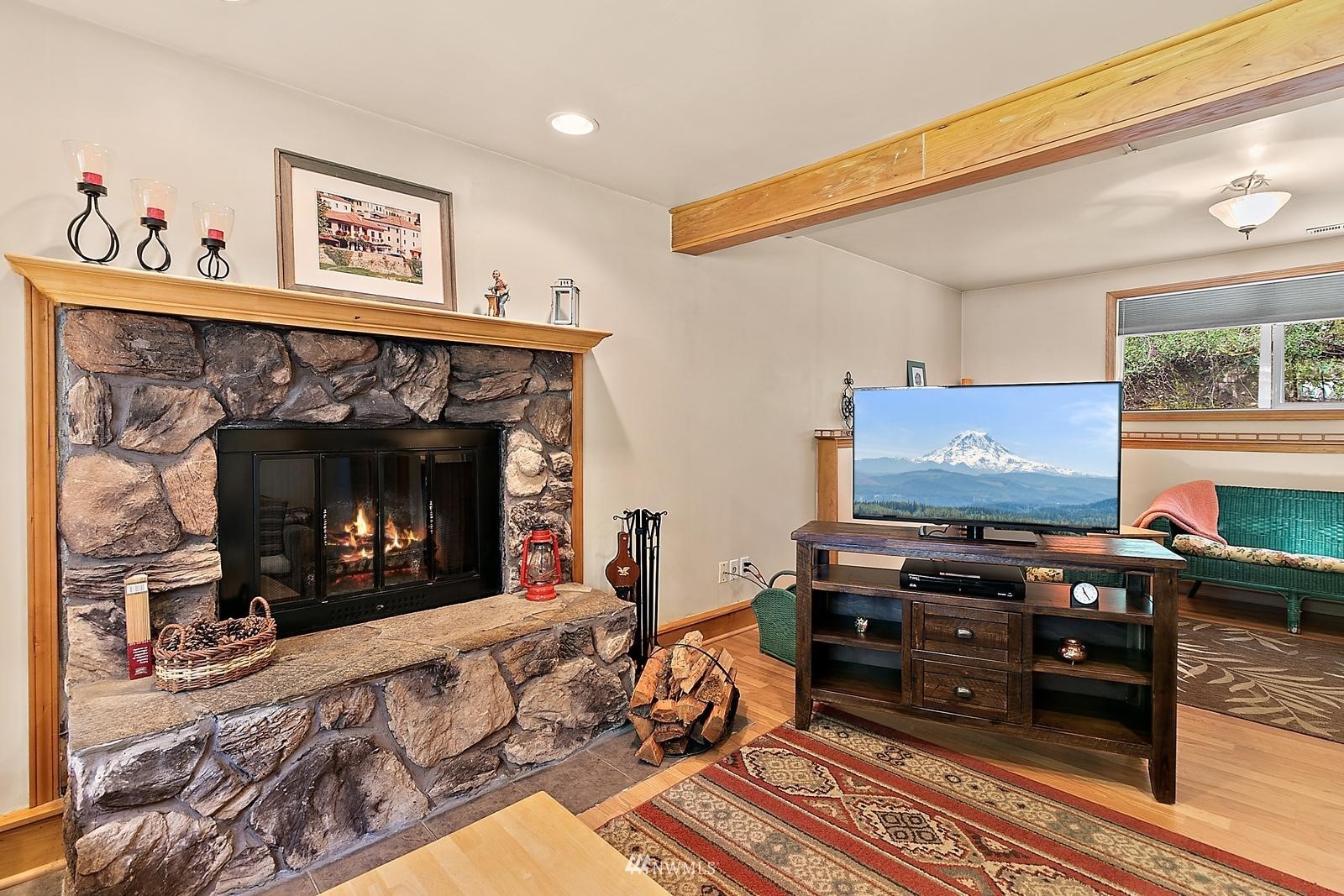 509 Roe Street Steilacoom, WA 98388 - Photo 27 of 40 a living room with furniture a fireplace and a flat screen tv