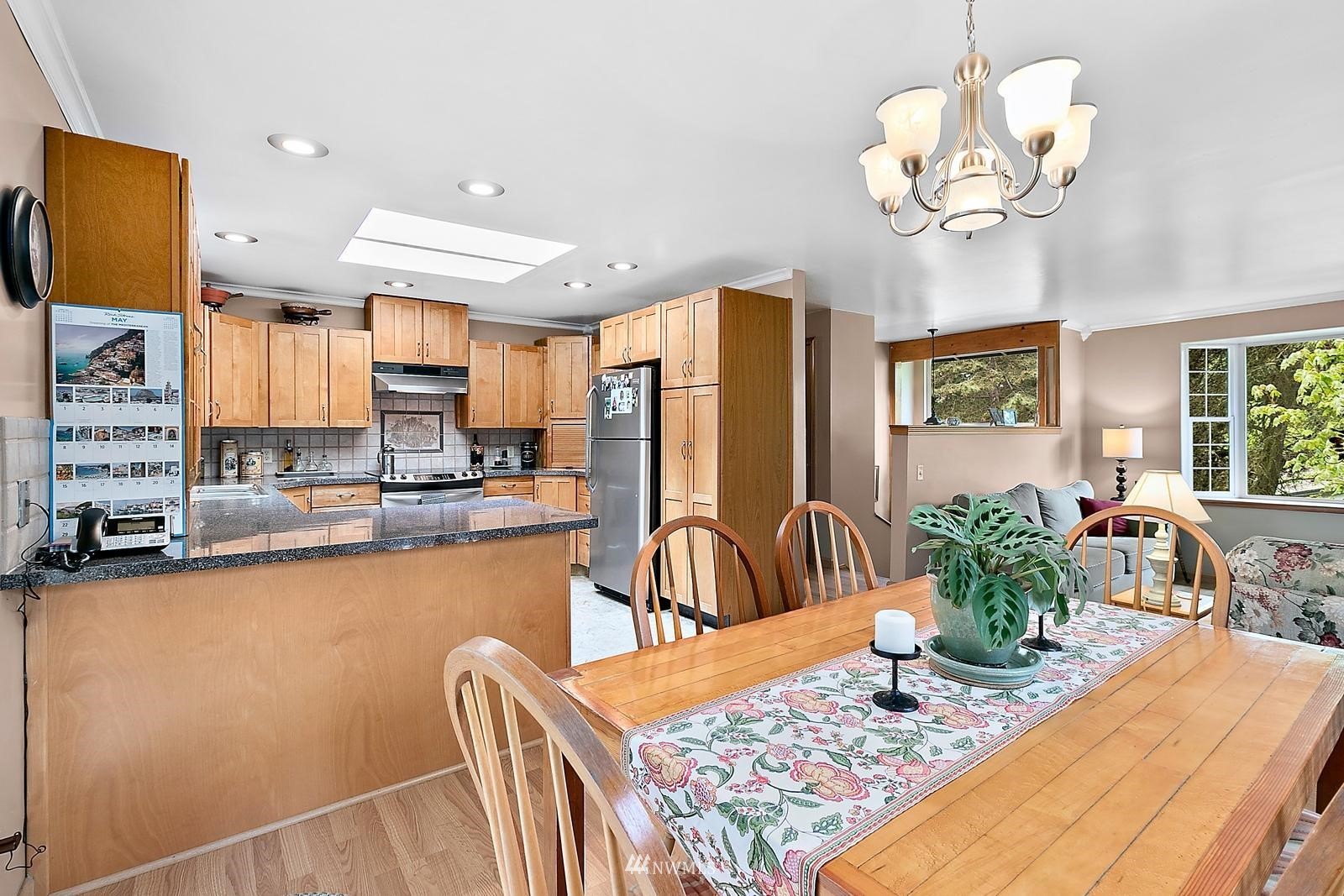 509 Roe Street Steilacoom, WA 98388 - Photo 3 of 40 a kitchen with granite countertop sink table and chairs