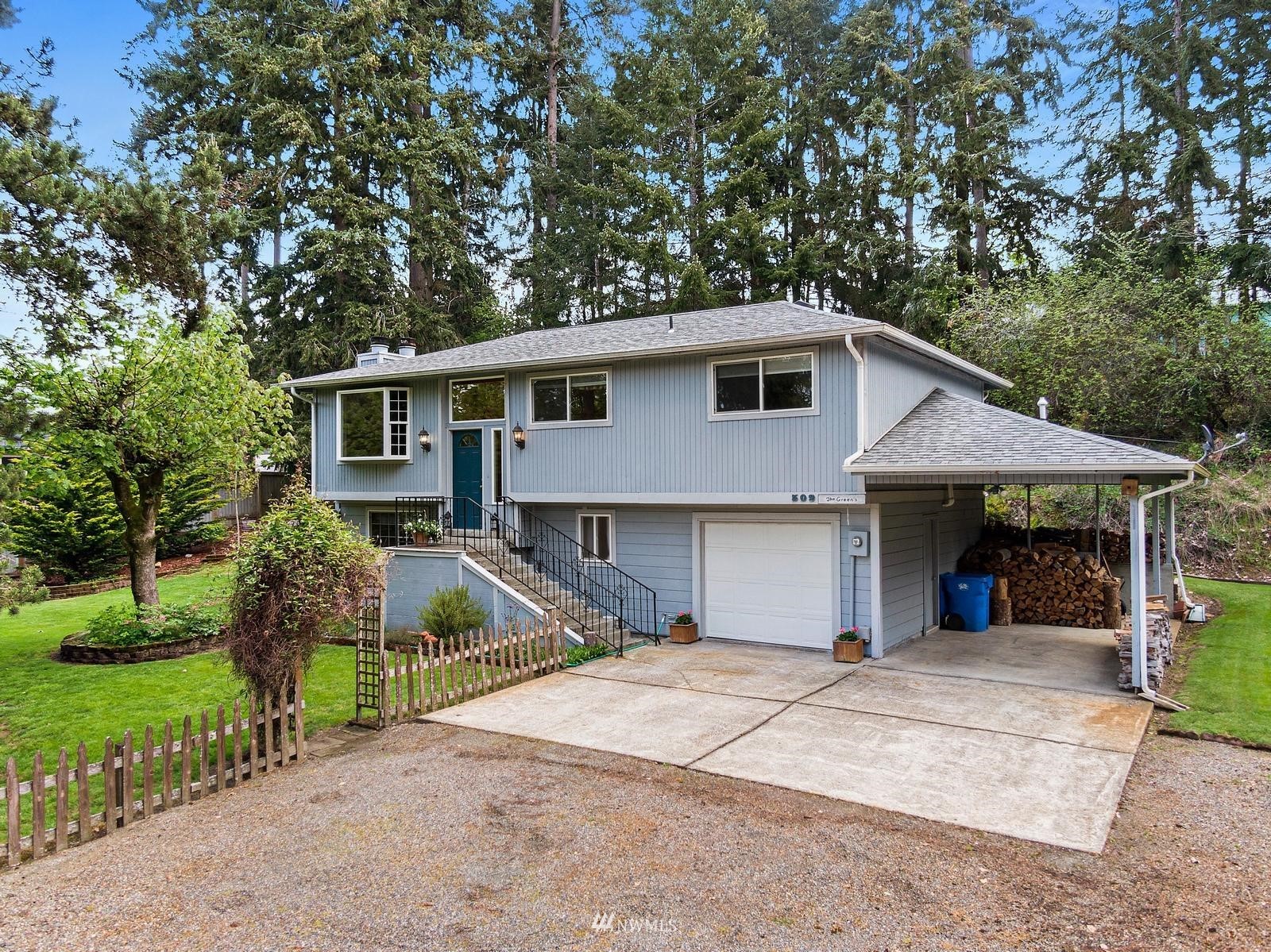 509 Roe Street Steilacoom, WA 98388 - Photo 39 of 40 a front view of a house with a garden and trees