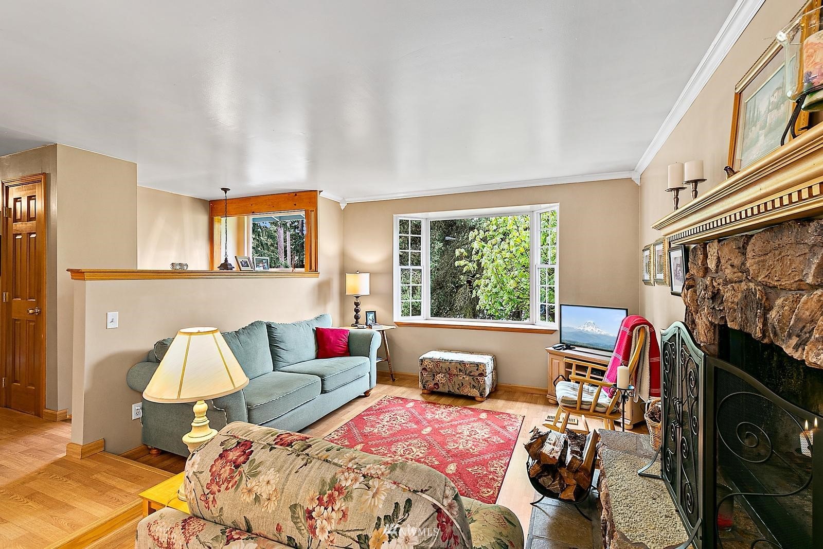 509 Roe Street Steilacoom, WA 98388 - Photo 4 of 40 a bedroom with a bed a couch and a window