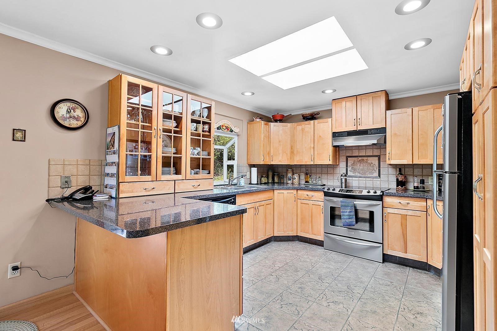 509 Roe Street Steilacoom, WA 98388 - Photo 7 of 40 a kitchen with stainless steel appliances granite countertop a stove and a sink