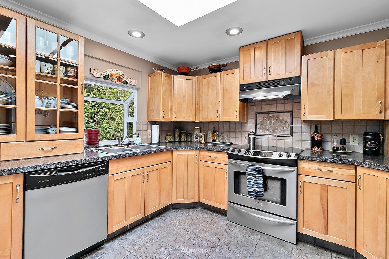 509 Roe Street Steilacoom, WA 98388 - Photo 10 of 40 a kitchen with stainless steel appliances granite countertop white cabinets granite counter tops and a window