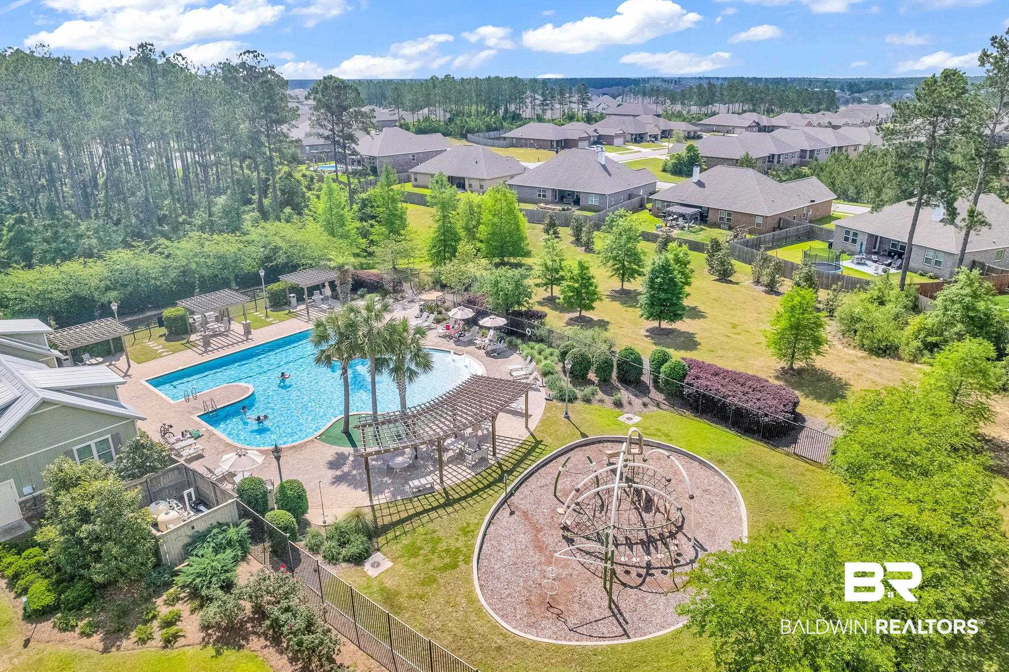 13233 Ibis Boulevard Daphne, AL 36527 - Photo 80 of 100 Community swimming pool with sun deck, multiple pergolas, and adjacent playground