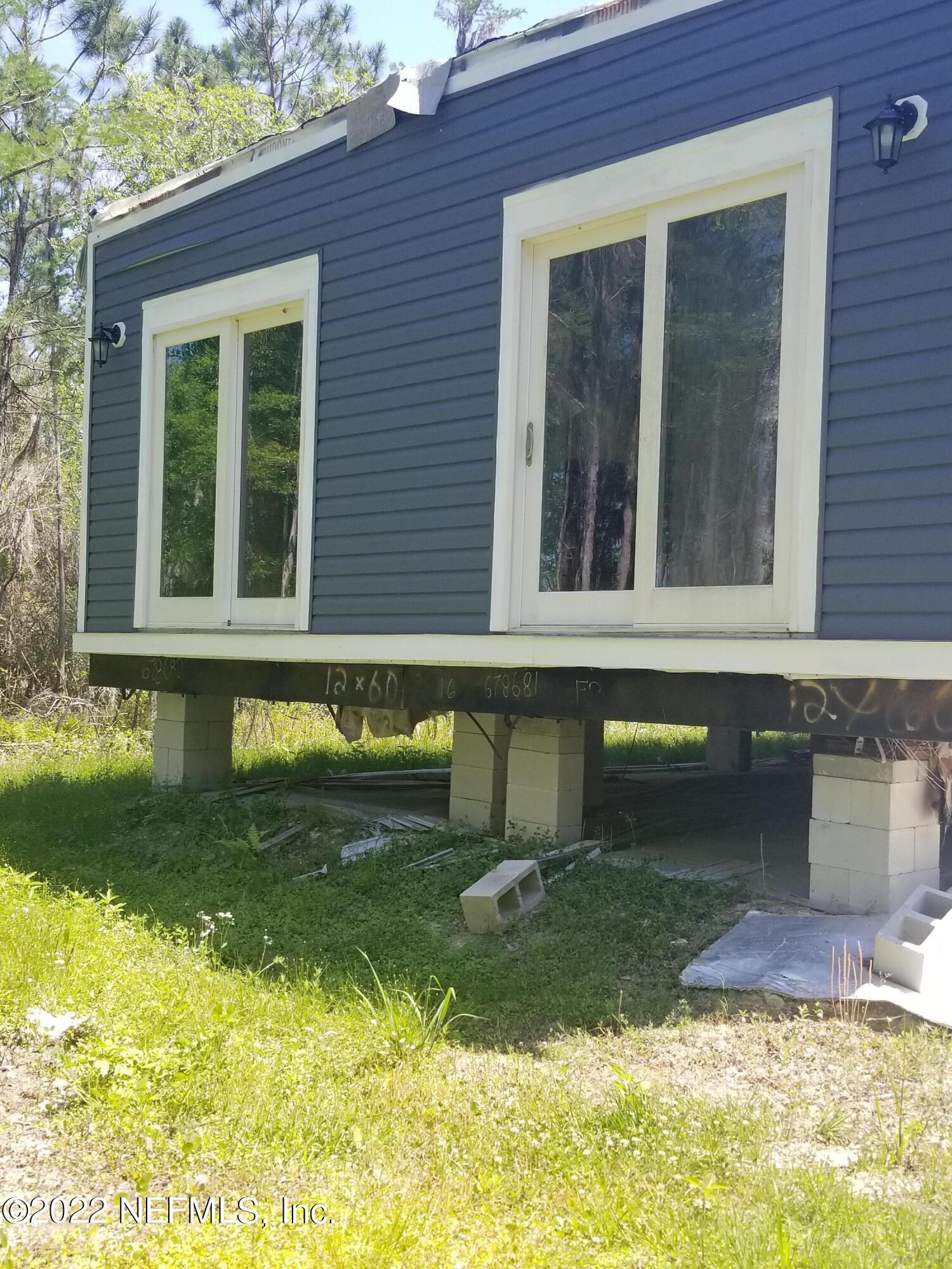 8505 Southwest 137th Street Starke, FL 32091 - Photo 3 of 10 a front view of a house with a yard