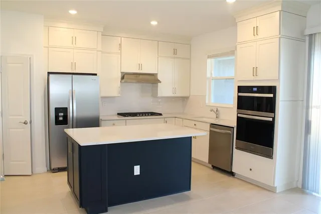 a kitchen with a sink a stove and refrigerator