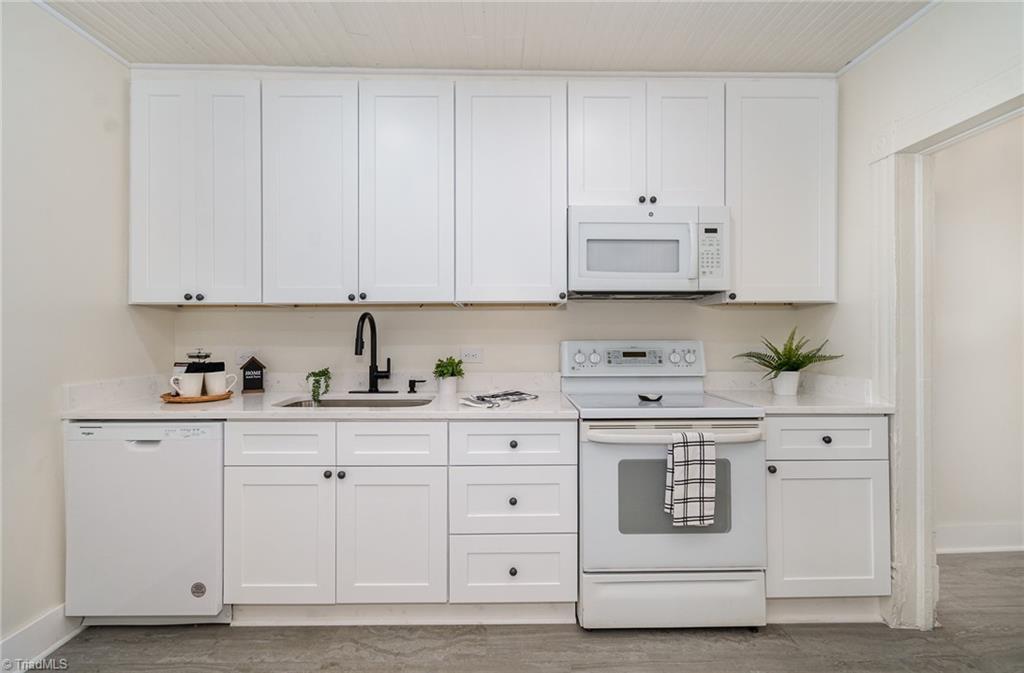 310 West Ray Avenue High Point, NC 27262 - Photo 12 of 28 Beautifully renovated modern Kitchen includes all appliances, granite counters, new cabinets and tile floors.