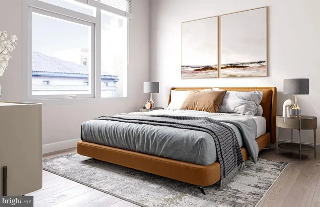 a bedroom with a bed and next to a window