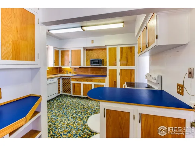 a kitchen with a sink cabinets and window