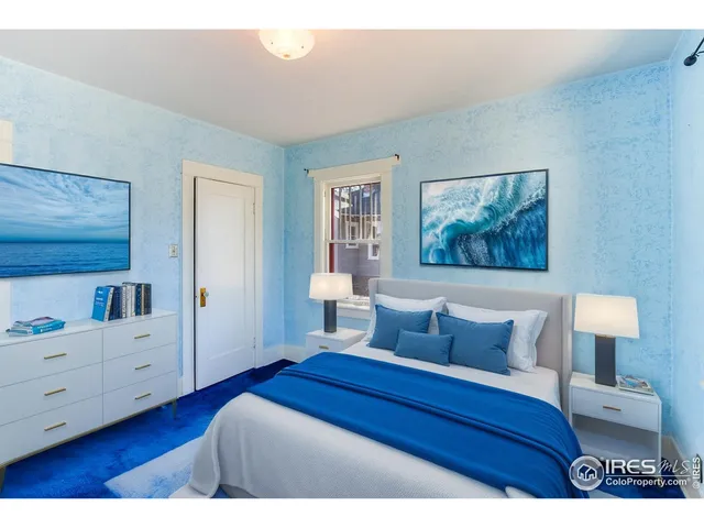 a bedroom with a bed and a night stand