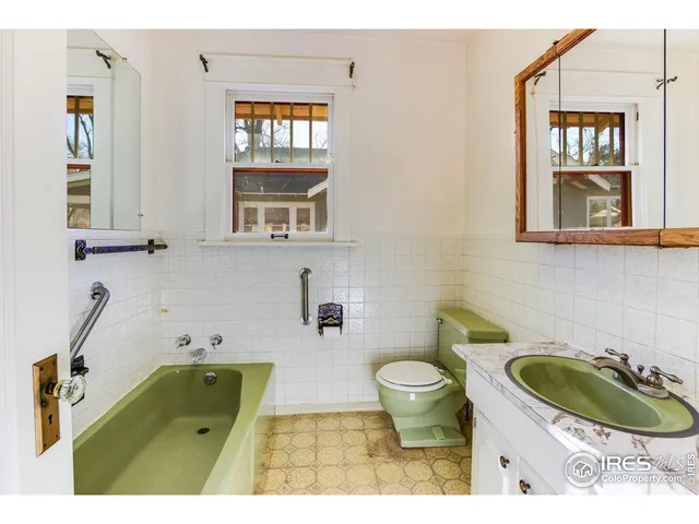 a bathroom with a sink a toilet and a window