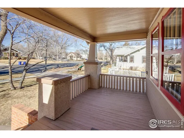a view of a open kitchen with wooden floor and iron stairs