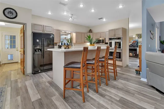 a kitchen with kitchen island granite countertop appliances cabinets and a sink