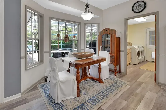 a view of a dining room with furniture and a large window