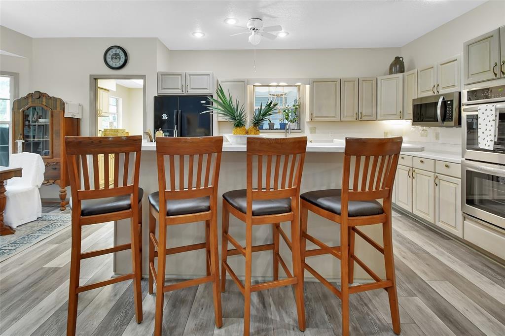 2236 River Ridge Road DeLand, FL 32720 - Photo 14 of 84 a view of a dining room with furniture window and wooden floor