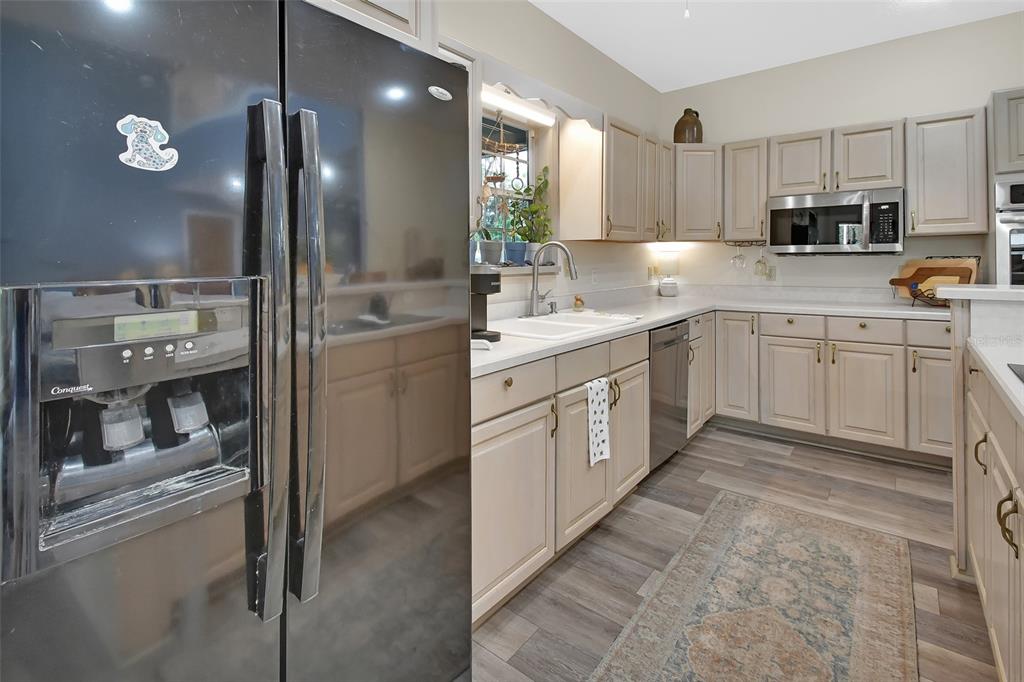 2236 River Ridge Road DeLand, FL 32720 - Photo 15 of 84 a kitchen with kitchen island granite countertop appliances cabinets and a sink