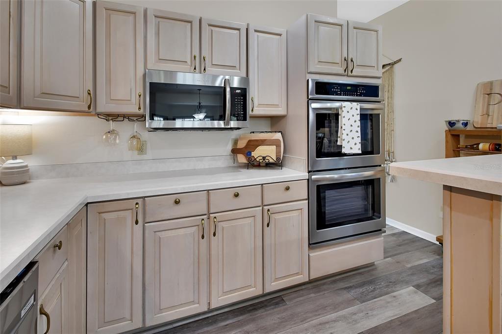 2236 River Ridge Road DeLand, FL 32720 - Photo 16 of 84 a kitchen with granite countertop white cabinets and stainless steel appliances