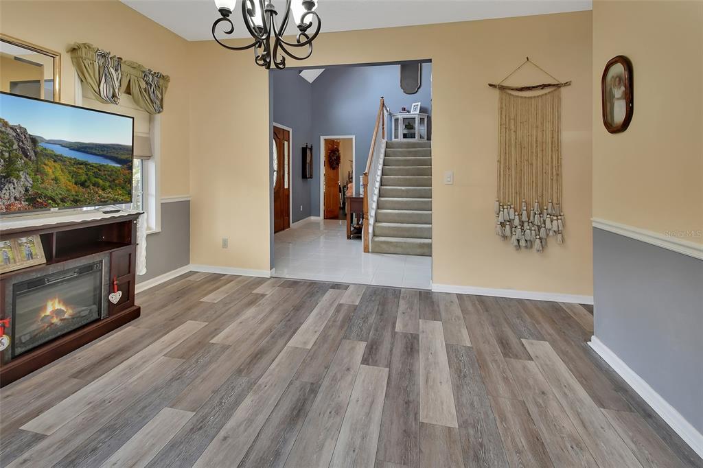 2236 River Ridge Road DeLand, FL 32720 - Photo 22 of 84 a view of an empty room with wooden floor and a fireplace