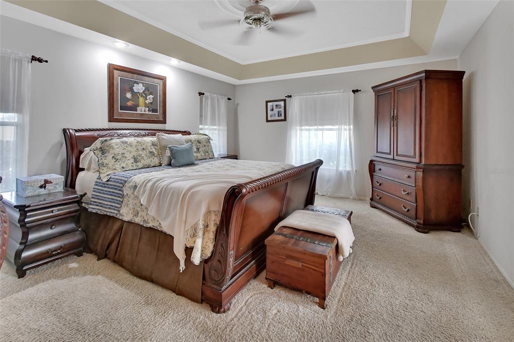 2236 River Ridge Road DeLand, FL 32720 - Photo 25 of 84 a bedroom with a bed and a chandelier