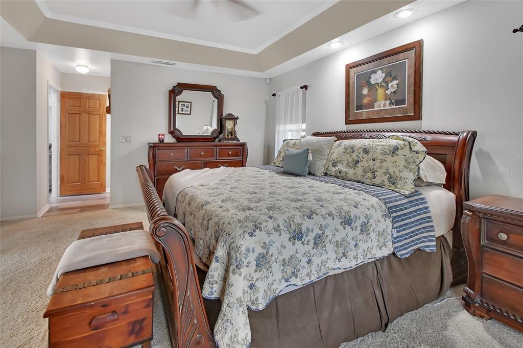 2236 River Ridge Road DeLand, FL 32720 - Photo 26 of 84 a bedroom with a bed and painting on the wall