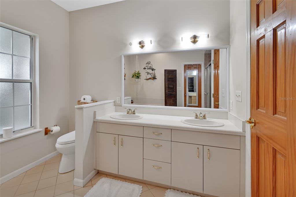 2236 River Ridge Road DeLand, FL 32720 - Photo 28 of 84 a spacious bathroom with a double vanity sink mirror and toilet