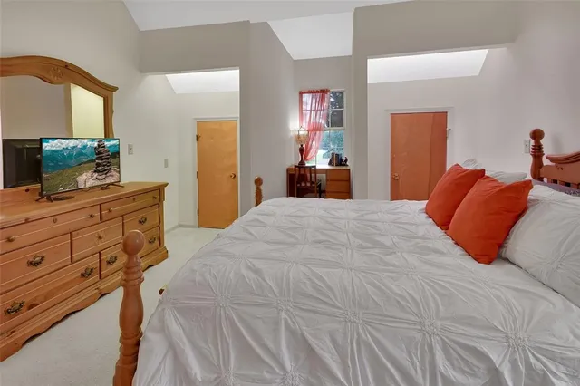 a roof deck with table and chairs and potted plants