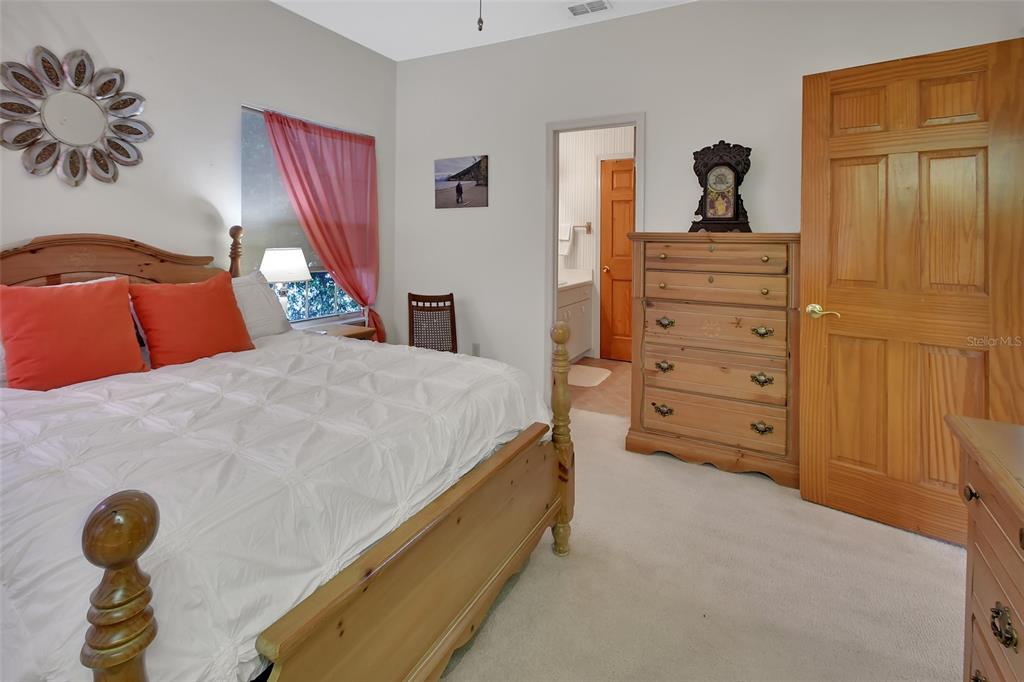 2236 River Ridge Road DeLand, FL 32720 - Photo 39 of 84 a bedroom with a bed and a chandelier