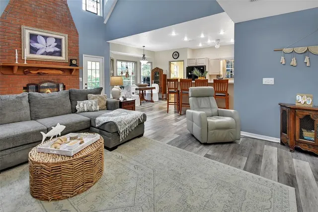 a dining room with furniture a rug and wooden floor