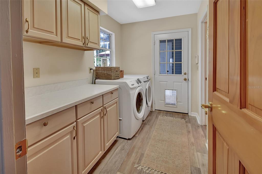 2236 River Ridge Road DeLand, FL 32720 - Photo 49 of 84 a utility room with cabinets washer and dryer